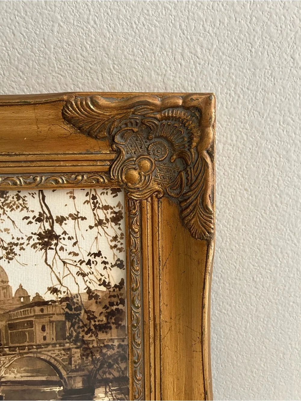 Framed art in gilded ornate frame